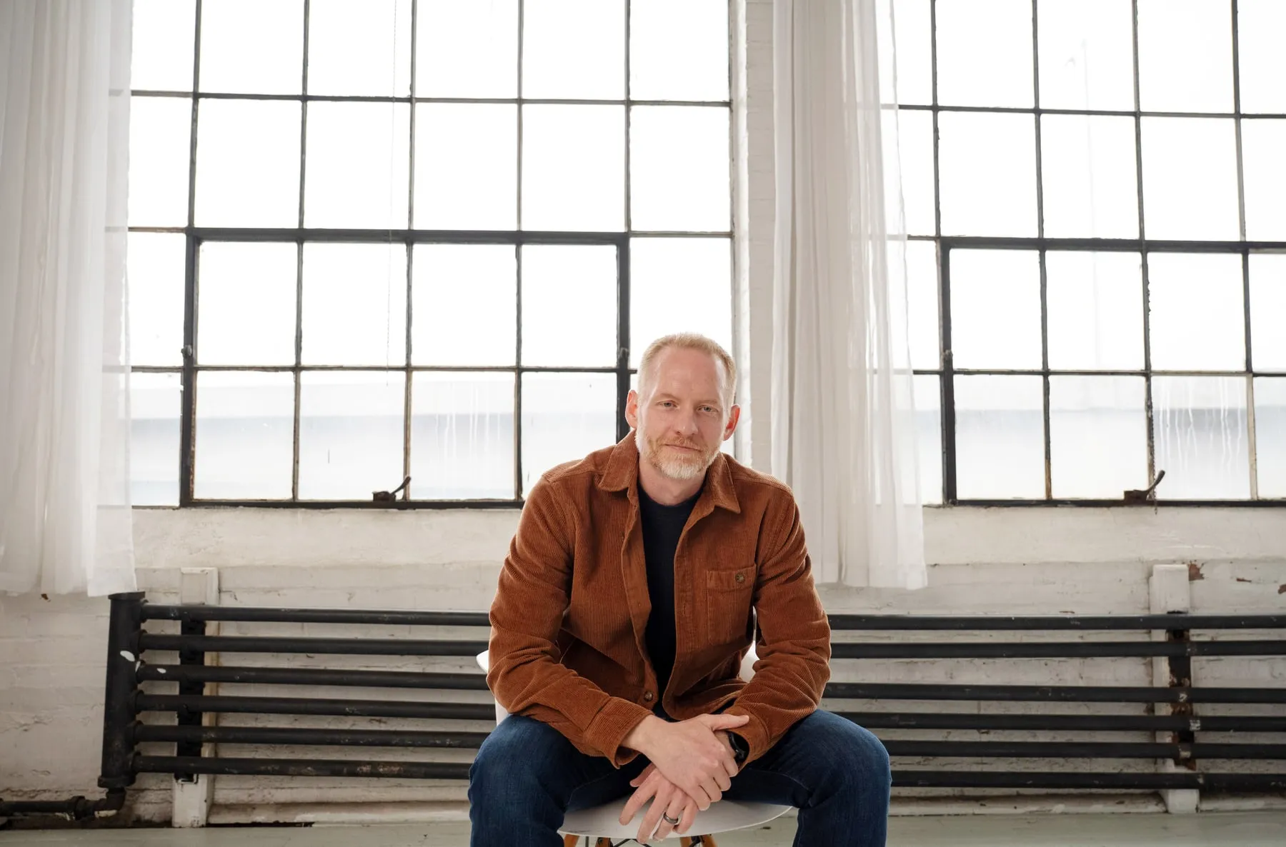 Preston Peterman, founder of Far Point Strategy, seated in a daylit studio loft