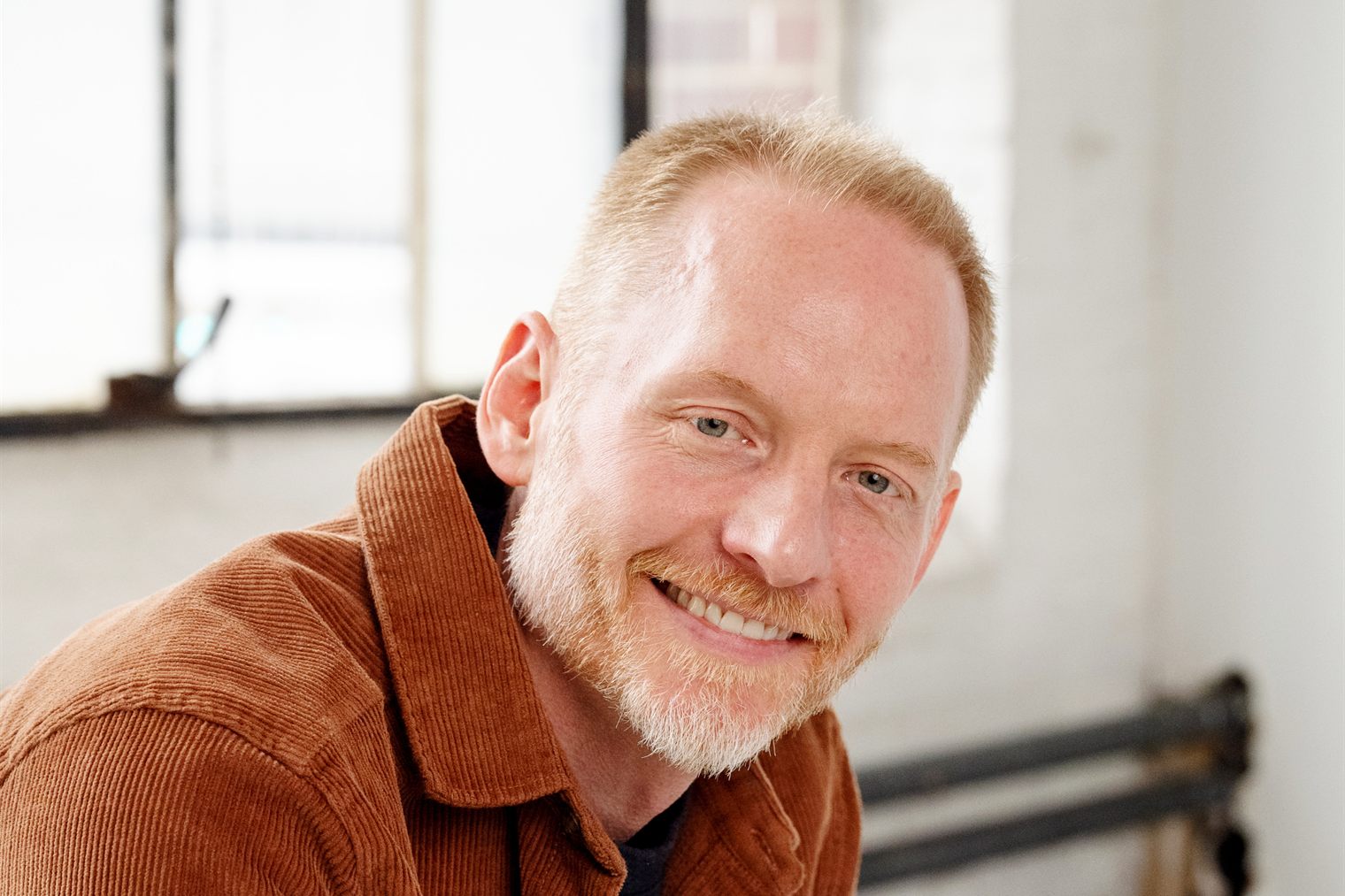 Preston Peterman, founder of Far Point Strategy, seated in a daylit studio